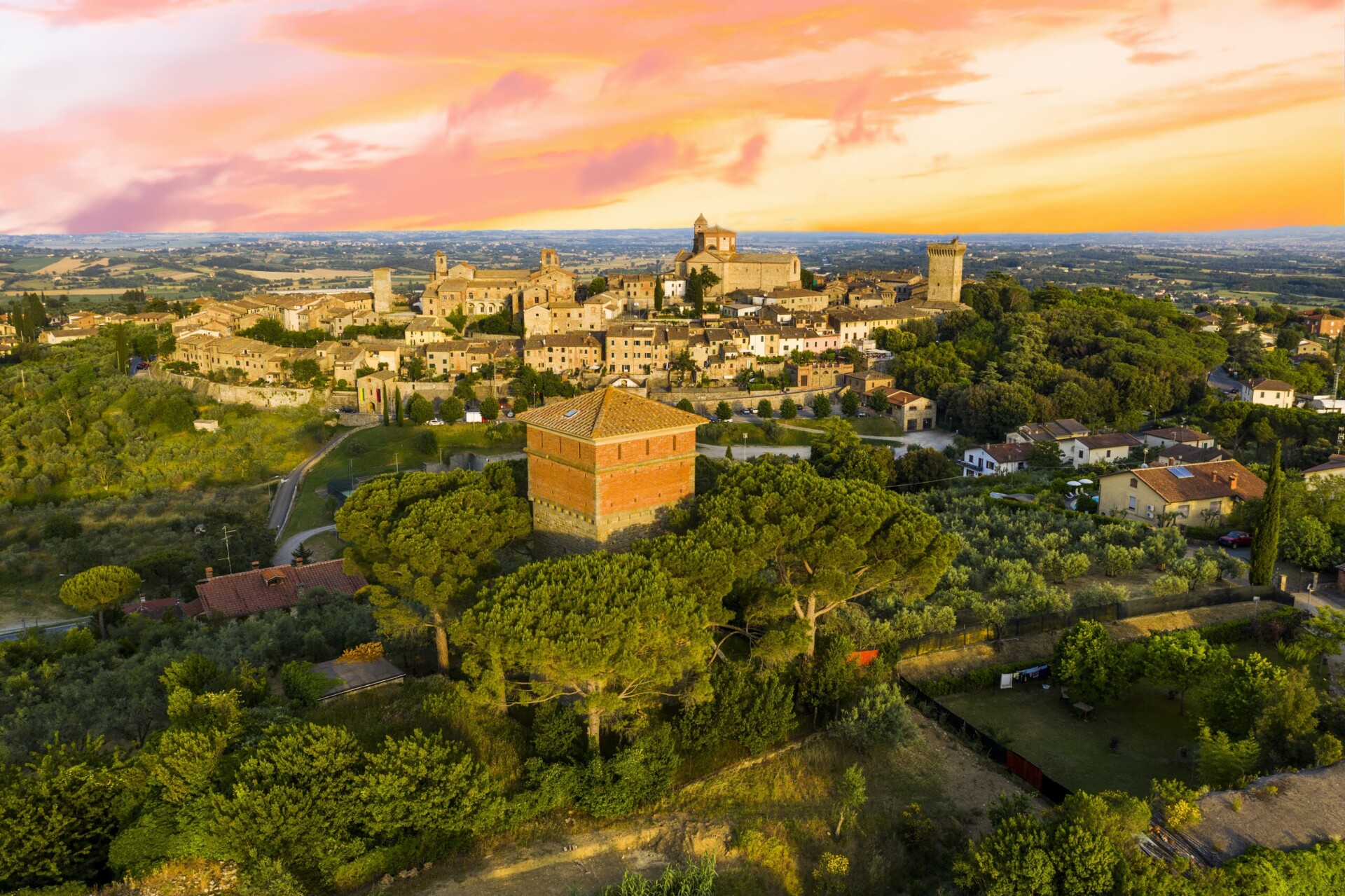 Evening sunset photo of small historic town Lucignano in Tuscany from above along with old Medici fort tower, Italy