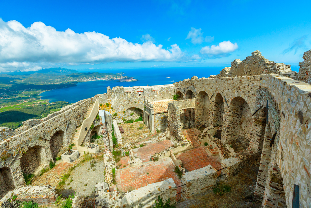 Aerial view of ruins of hexagonal Castello del Volterraio or Volterraio Castle, the oldest fortification on Elba Island, Tuscany, Italy, overlooking the gulf of Portoferraio. Panoramic views of Elba.
