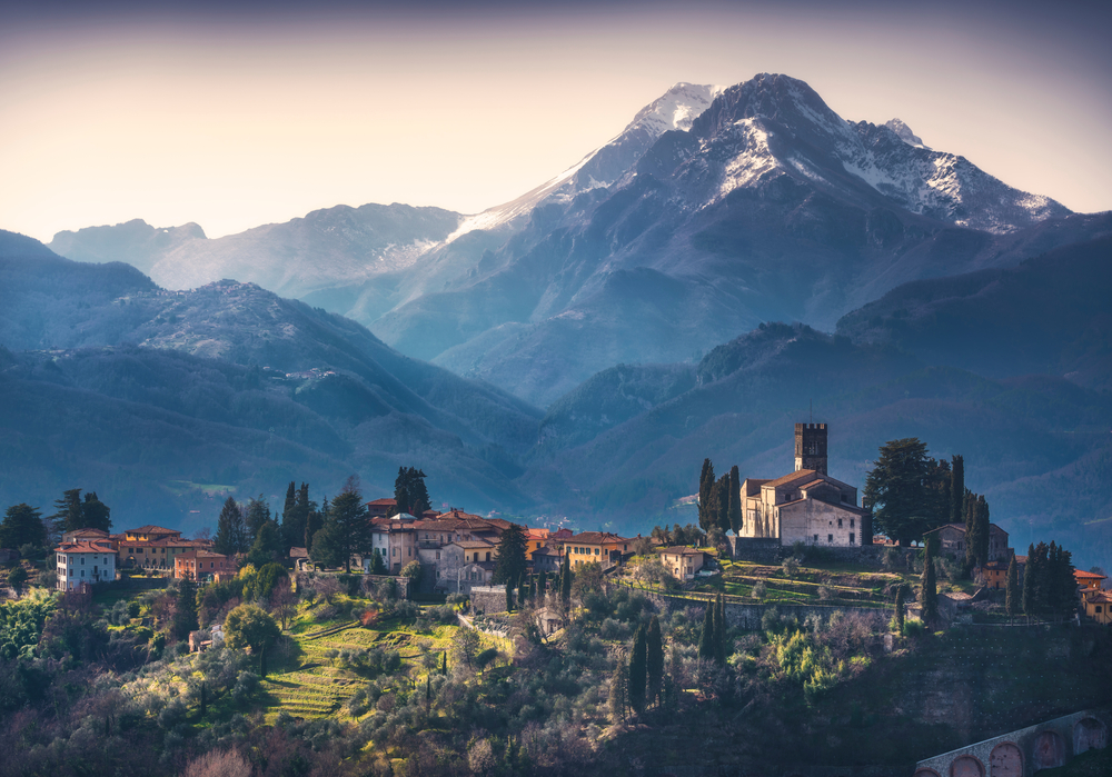 Barga town and Alpi Apuane mountains in winter. Garfagnana, Tuscany, Italy Europe