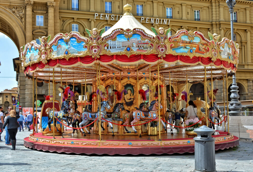 Beautiful carousel. Tourists relax at the Republic Square in Florence. Arcone Triumphal Arch. Landmarks and tourist attractions. Italian architecture. Sightseeing. Italy, Florence – April 17, 2018   