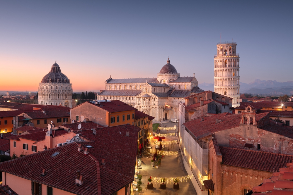 Pisa, Italy with the Duomo and Leaning Tower at dusk.