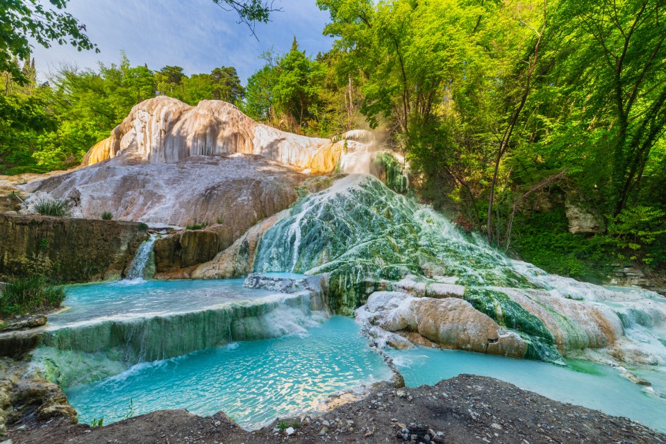 Bagni di San Filippo, Geothermal pool and hot spring in Tuscany, Italy. Bagni San Filippo natural thermal waterfall in the morning with no people. The White Whale amidst forest.