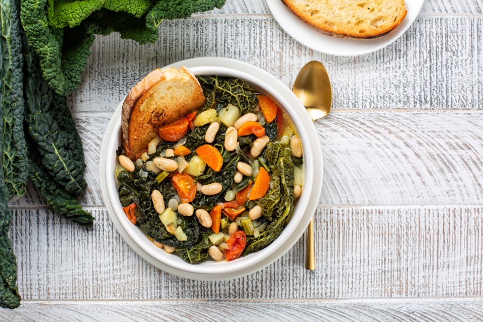Kuchnia w Toskanii, Top view of Ribollita. Tuscan bread soup made with toasted bread and vegetables. Cannellini beans, lacinato kale, cabbage verza, carrot, celery, potatoes, and onion. Itralian food. Directly above.